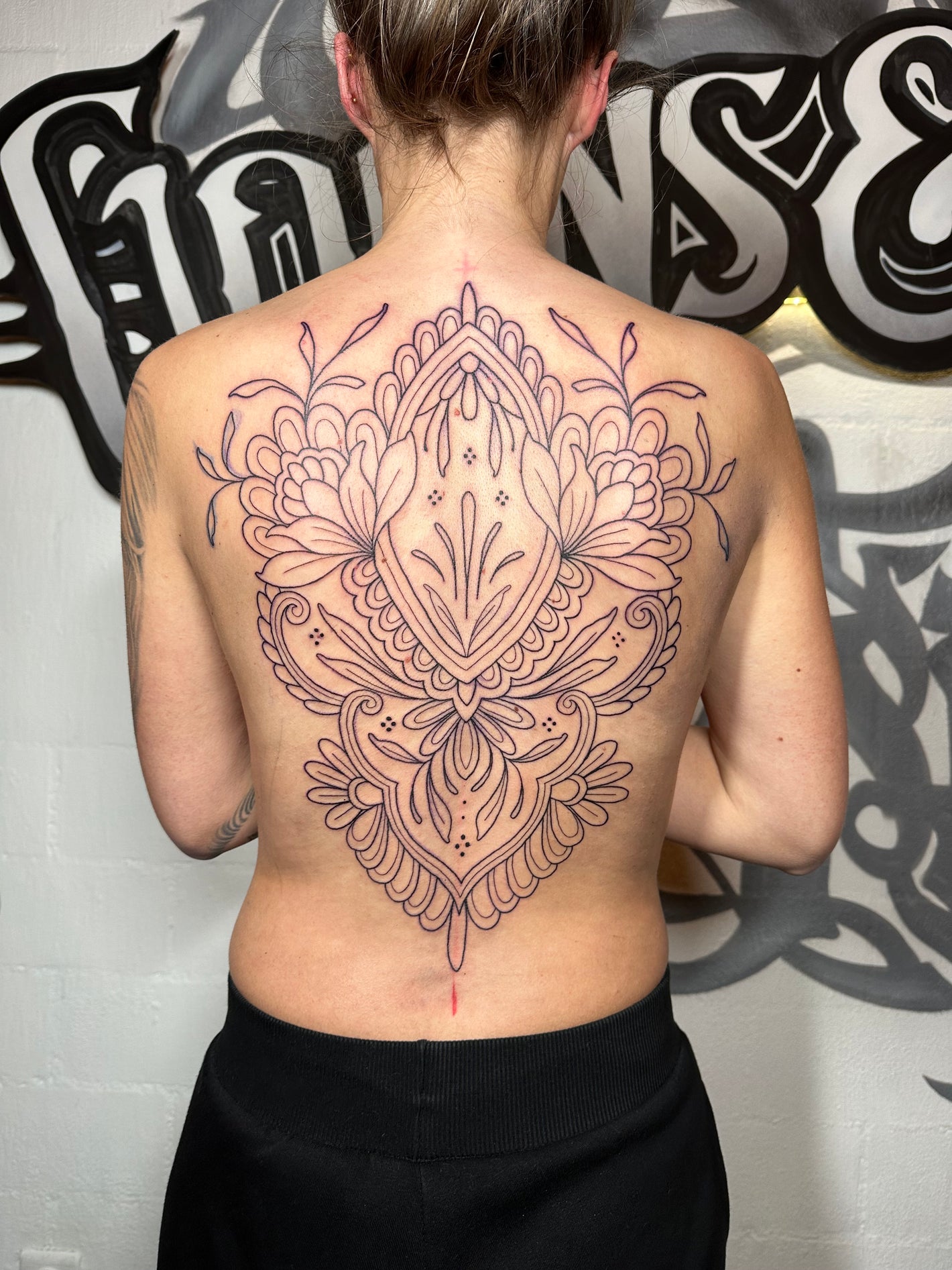 Back peace female tattoo